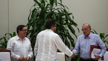 Humberto de La Calle, right, head of Colombia's government peace negotiation team, right, shakes hands with Ivan Marquez, chief negotiator of the Revolutionary Armed Forces of Colombia, or FARC in Havana, Cuba.