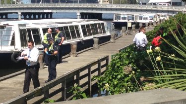 Police at the scene where a body was found in the Yarra River.