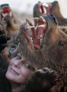 A girl poses with a bear fur during New Year ritual dances in Comanesti, 300 kilometres north of Bucharest, Romania.