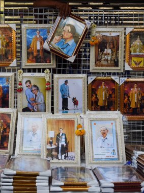 A man sells portraits of King Bhumibol Adulyadej on the street in Bangkok on Friday.