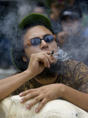 A man smokes a marijuana cigarette during a protest in Mexico City.