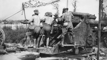 Gunners of the Australian Siege Artillery Brigade ramming home a shell in a 9.2 inch breech loading howitzer on a hot summer's day. The batteries of this brigade were among those that supported the I Anzac Corps at Pozieres.