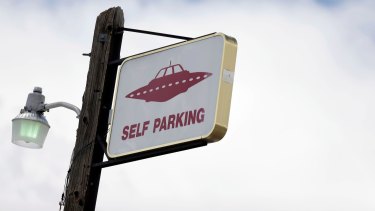 A sign indicates UFO parking at the Little A'Le'Inn, located 15 kilometres up the road from the military testing base known as Area 51, in Rachel, Nevada.