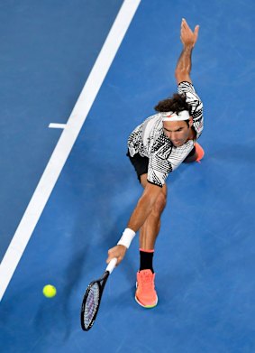 Federer stretches out for a backhand return.