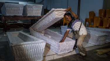 A man prepares coffins ahead of the executions of Bali nine pair Andrew Chan and Myuran Sukumaran.