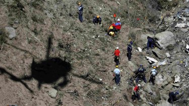 Investigators work amongst debris at crash site of the Germanwings flight.