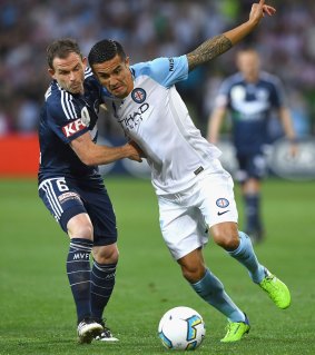 Victory's Leigh Broxham  and Tim Cahill compete for the ball.