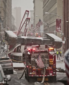 A collapsed crane lies upside down along Worth Street.