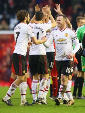 Captain fantastic: Rooney celebrates with his teammates.