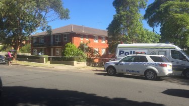 The body of a woman was found at the rear of the property about 1.15pm. 
