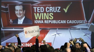 Cruz supporters cheer as caucus returns are reported.