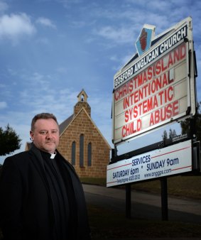 Father Rod Bower with one of his signs.