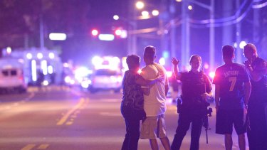 Police officers direct people away from the nightclub in Orlando, Florida,  