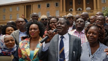 Kenyan opposition leader Raila Odinga, centre, addresses his supporters as he leaves the Supreme Court on Friday.