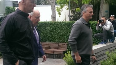 Alan Jones, Steve Waugh, right, and  Channel Ten reporter Andrew Denney, left, leave the hospital together.