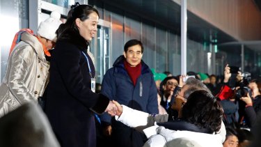Kim, left, shakes hands with Moon Jae-in at the opening ceremony of the 2018 Winter Olympics in Pyeongchang.