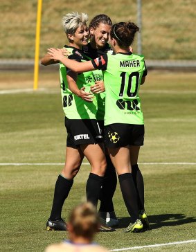 Michelle Heyman celebrates with teammates after scoring a goal during the round four W-League match between Canberra United and the Newcastle Jets at McKellar Park.