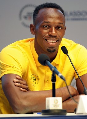Usain Bolt mania: The Olympic champion's entourage to his news conference included two police officers wielding sub-machine guns.