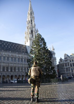 A Belgian soldier patrols in the deserted Grand Place in Brussels on Monday.