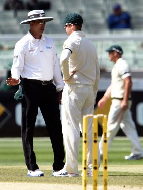 Umpire Kumar Dharmasena has a word with Steve Smith about the chatter on the field.