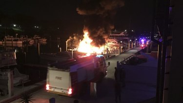 The fire takes hold of two boats at Woolloomooloo on Saturday.