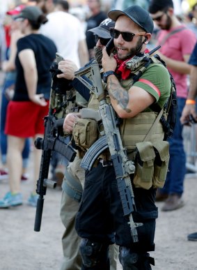 Members of the John Brown Gun Club and Redneck Revolt protest outside the Phoenix Convention Centre on Tuesday.
