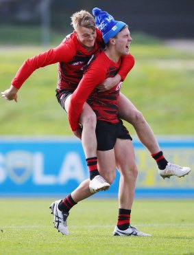 Mason Redman brings out the whip on Josh Begley during an Essendon training session.