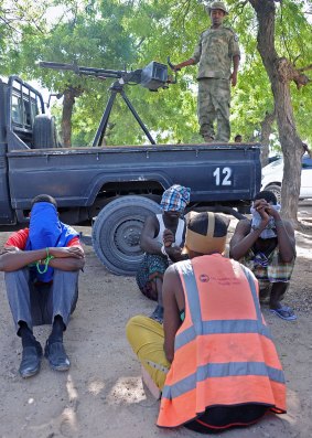 Four suspected al-Shabab fighters are detained by Somali troops after a gun battle in Mogadishu on Friday.