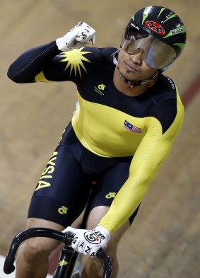 Malaysian cyclist Azizulhasni Awang wears gloves with the words "Save Gaza" on them during the men's sprint.