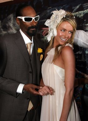 Suited rapper Snoop Dogg with model Jennifer Hawkins. “The party vibe went up 100 per cent” when he arrived at a Birdcage marquee, recalls an organiser.