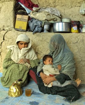 "The interesting thing . . . is that the mother then, out of habit and tradition, becomes identified by the child": an Afghan woman with her daughter and son in Shomali, 30 kilometres north of Kabul.