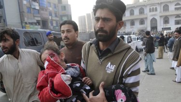 A Pakistani girl, who was injured in a Taliban attack in a school, is rushed to a hospital in Peshawar.
