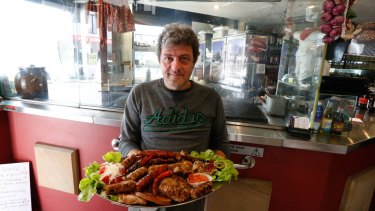 Macedonian community member  Alex Dzepovski with a plate of traditional grilled meat and pork dish at the Europe Grill Macedonian restaurant in Newtown.