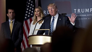 Donald Trump with daughter Ivanka Trump and son Donald Trump Jr.during the grand opening ceremony of the Trump International Hotel in Washington in October. The family's new hotel chain will be aimed at the crowds.