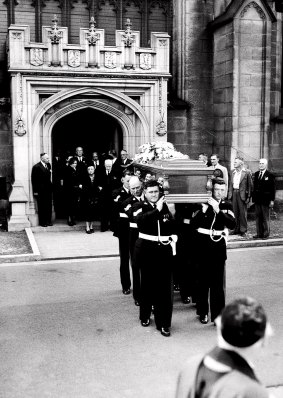 The coffin is carried from the Cathedral before being placed on the gun-carriage. Dame Mary Hughes followed.