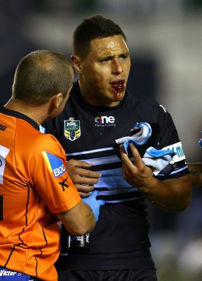The aftermath: Anthony Tupou leaves the field with multiple fractures to his jaw.