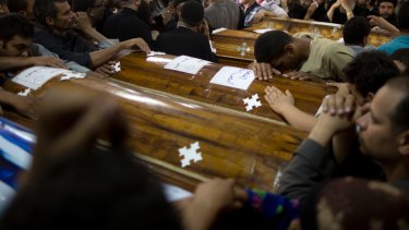 Relatives mourn the deaths of the Christians .
