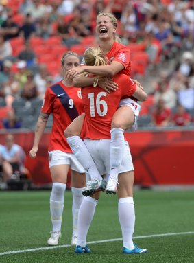 Norway's Ada Hegerberg  jumps into the arms of teammate Elise Thorsnes as she celebrates her goal.