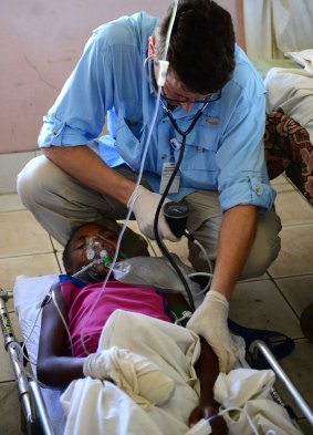 An Australian doctor attends to a young girl at the Lenakel Hospital on Tanna.