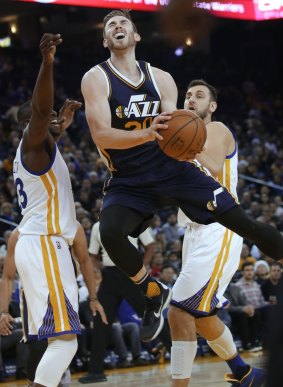 Utah Jazz's Gordon Hayward goes up for a shot between Golden State Warriors' Draymond Green (left) and Andrew Bogut during the second half of the NBA game on Wednesday.