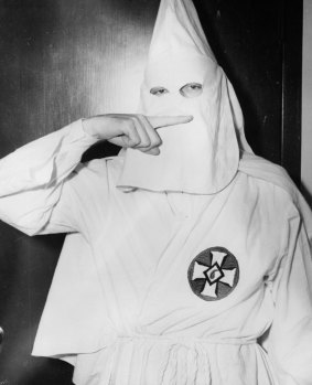 Stetson Kennedy, author of the Ku Klux Klan study 'Southern Exposure' poses in the Klan's uniform to illustrate the group's Oath Of Secrecy.