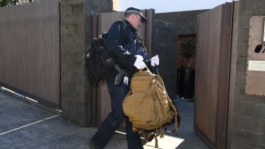 Police search the home of John Ibrahim on Tuesday morning. 