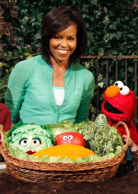Former first lady Michelle Obama used her status to promote healthy eating habits with Elmo from <i>Sesame Street</i>. 