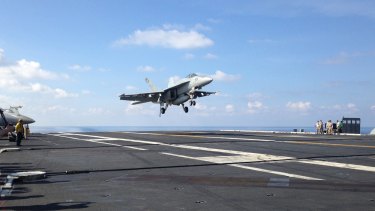 An FA-18 jet fighter lands on the USS John C. Stennis aircraft carrier in the South China Sea last month.