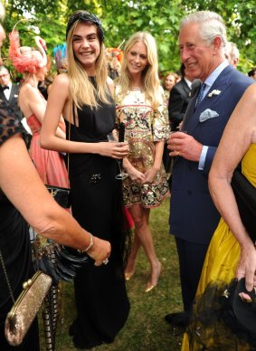 Meeting Prince Charles at a 2013 charity reception with sister Poppy.