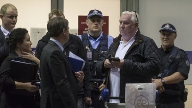 Concert promoter Andrew McManus being detained by police at Melbourne Airport on Thursday night.