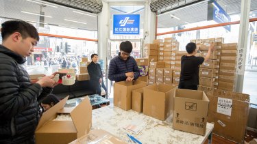 Workers and customers at the Chang Jiang International Express store on Swanston Street in  Melbourne package up Australian goods for export to China. 