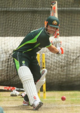 Ready to go: Dave Warner tests his thumb in the nets.