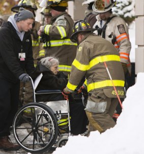Firefighters attend to patients from Garden Gate Health Care Facility in  Cheektowaga near Buffalo. 180 patients  were evacuated after roof issues caused by snowfall. 