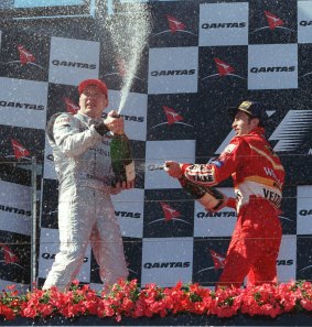 David Coulthard and Heinz-Harald Frentzen spray champagne on the podium at the 1998 Australian Grand Prix.